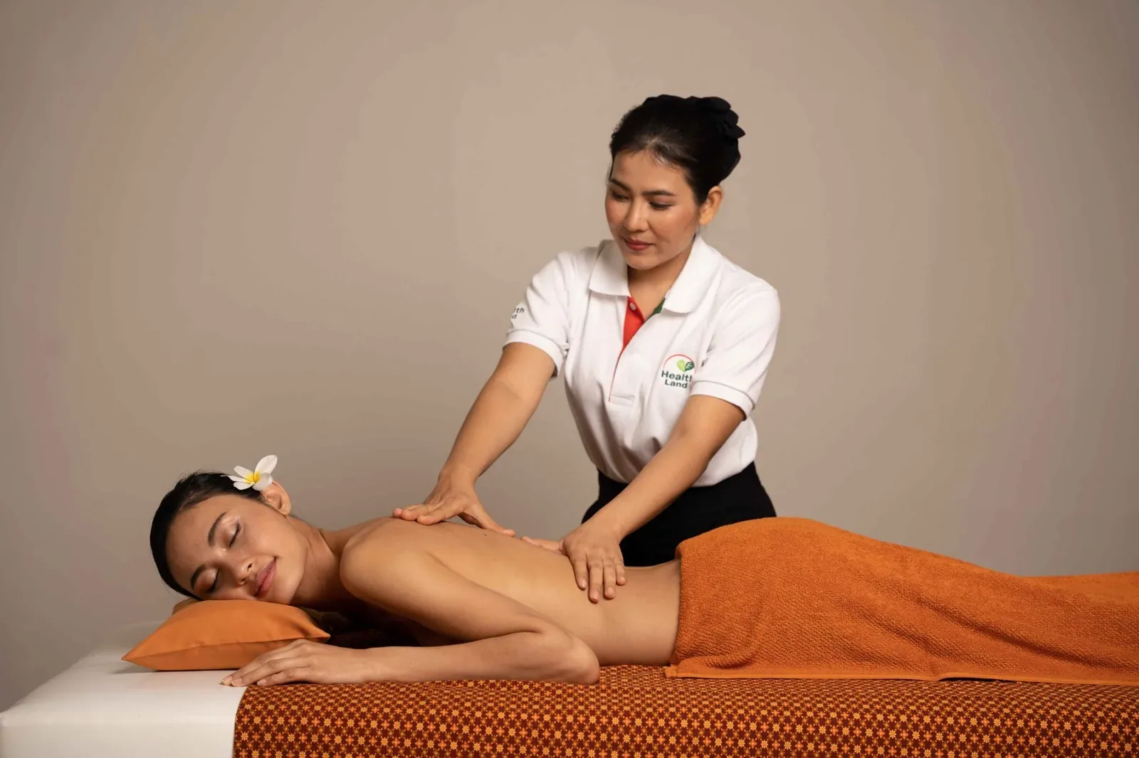 Health Land therapist performing an oil massage