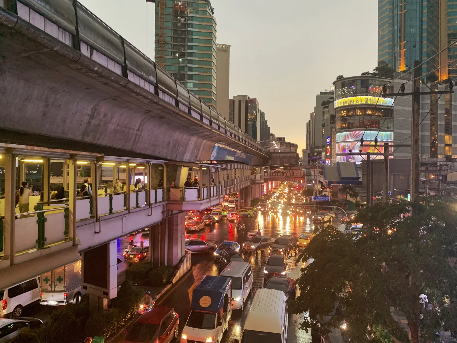 Sukhumvit Road at Asok at dusk, with the BTS station above the traffic