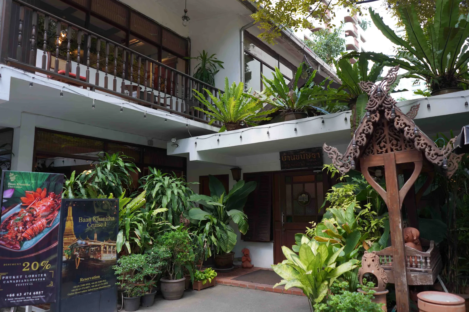 White Thai house and garden entrance at Baan Khanitha Sukhumvit 23