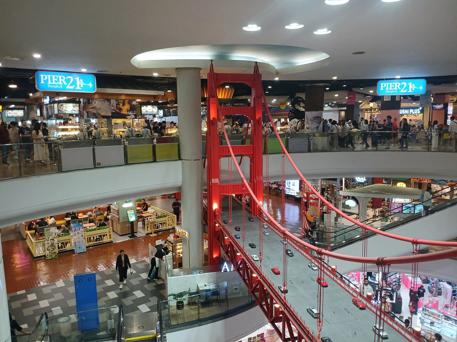 Terminal 21 Asok interior with a red London-style bridge and Pier 21 signage