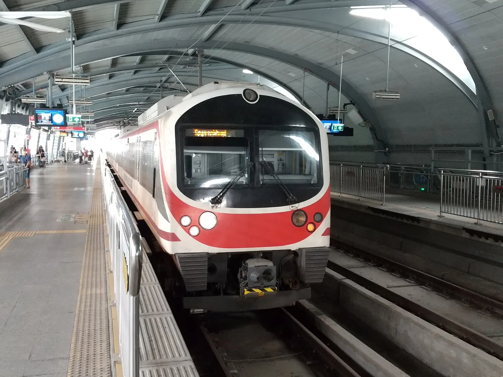 Red and white Airport Rail Link train standing at Phaya Thai station