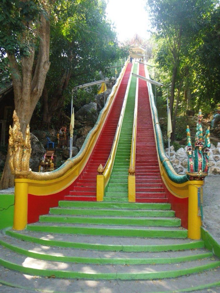 Giant golden Buddha of Wat Tham Suea above the rice plain